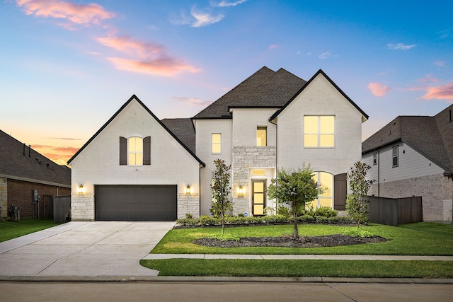 6523 Poplar Meadow Ln, Katy, TX 77493 - french country inspired facade featuring stone siding, concrete driveway, a garage, and brick siding