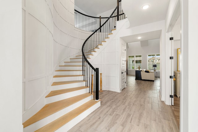 6523 Poplar Meadow Ln, Katy, TX 77493 - foyer with a towering ceiling, stairs, light wood finished floors, recessed lighting, and a decorative wall