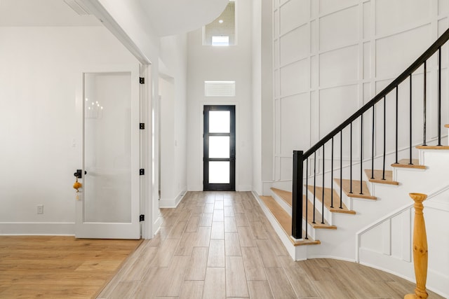 6523 Poplar Meadow Ln, Katy, TX 77493 - entryway with healthy amount of natural light, a high ceiling, light wood-style floors, and stairway