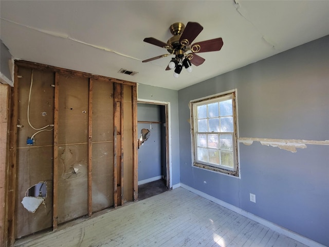 506 S Iowa St, La Porte, TX 77571 - unfurnished bedroom featuring a closet, a ceiling fan, and wood finished floors
