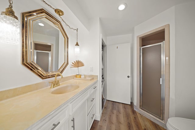 15722 Falmouth Dr, Houston, TX 77059 - full bath featuring vanity, a shower stall, wood finished floors, and recessed lighting