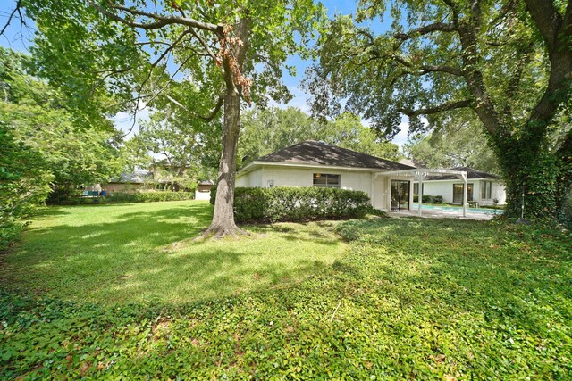 15722 Falmouth Dr, Houston, TX 77059 - view of grassy yard with a pergola and a patio