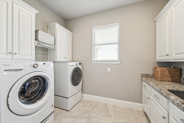 32319 Tall Oaks Way, Magnolia, TX 77354 - laundry area featuring separate washer and dryer, cabinet space, and light marble finish floors