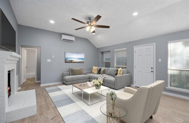 5622 Lycomb Dr, Houston, TX 77053 - living room with a wall mounted AC, ceiling fan, a fireplace, lofted ceiling, and light wood-type flooring