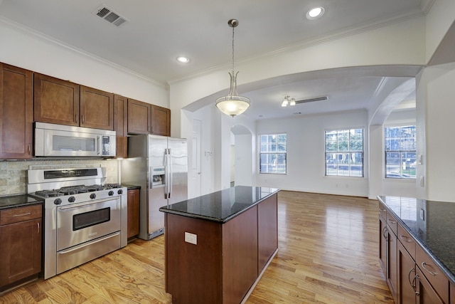 7539 Highmeadow, Houston, TX 77063 - kitchen with stainless steel appliances, arched walkways, light wood finished floors, dark stone counters, and ornamental molding