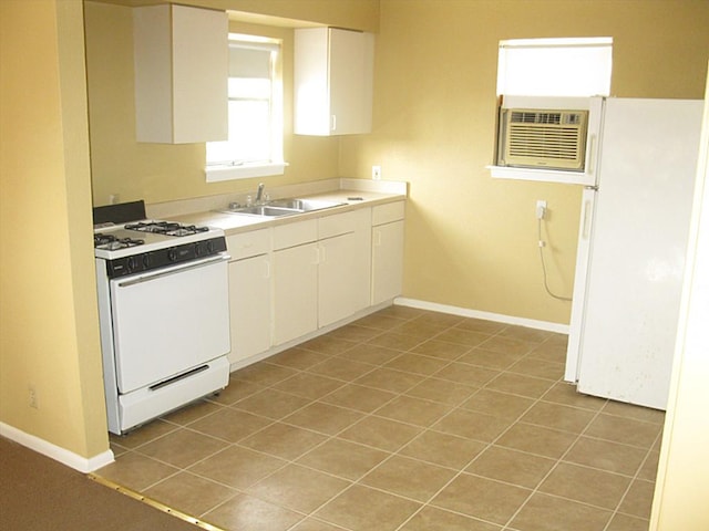 4911 Delano St, Houston, TX 77004 - kitchen featuring white appliances, white cabinetry, light tile patterned flooring, and light countertops