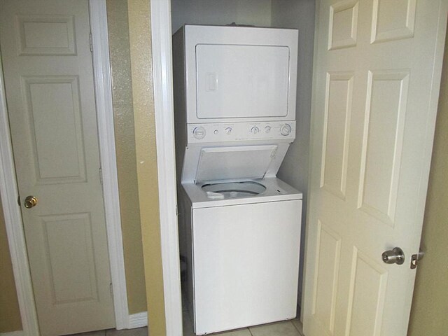 4911 Delano St, Houston, TX 77004 - laundry room with estacked washer and dryer and light tile patterned floors