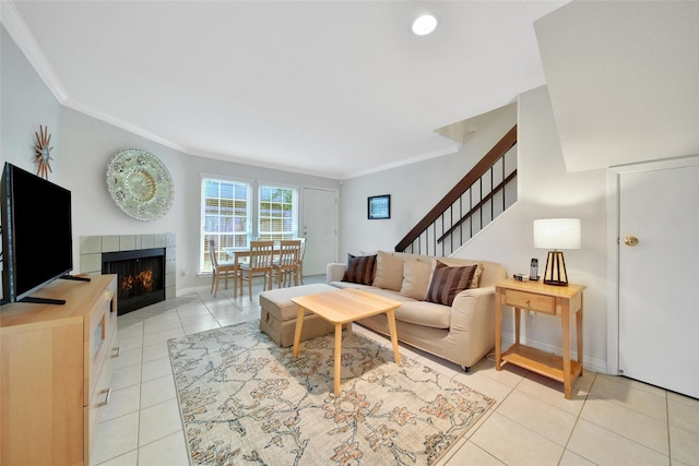 2002 Gentryside Dr Unit 117, Houston, TX 77077 - living area with crown molding, a tile fireplace, light tile patterned floors, and stairs
