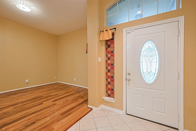 3803 Doveswood Cir, Needville, TX 77461 - entryway featuring a textured ceiling and light tile patterned floors