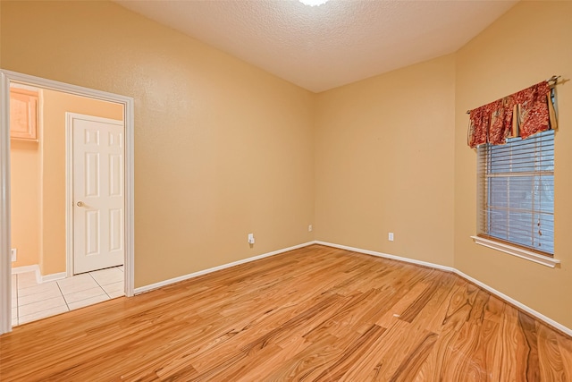 3803 Doveswood Cir, Needville, TX 77461 - empty room with light wood-type flooring and a textured ceiling