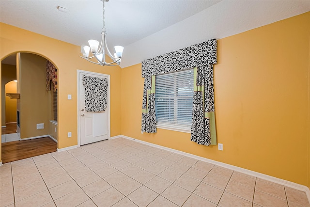 3803 Doveswood Cir, Needville, TX 77461 - spare room featuring arched walkways, a chandelier, and light tile patterned floors