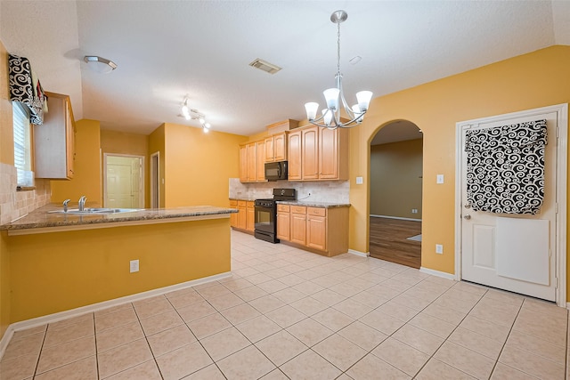 3803 Doveswood Cir, Needville, TX 77461 - kitchen featuring black appliances, light brown cabinets, arched walkways, tasteful backsplash, and light tile patterned floors