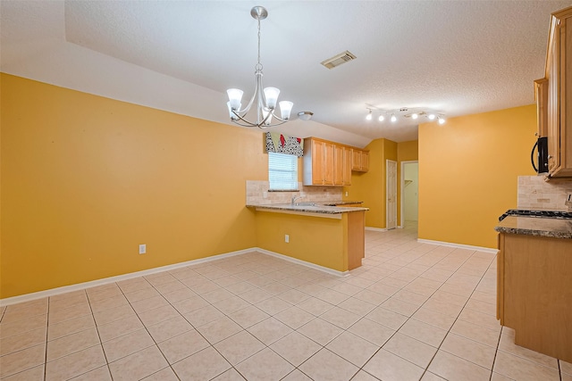3803 Doveswood Cir, Needville, TX 77461 - kitchen featuring backsplash, light tile patterned floors, black microwave, a peninsula, and a textured ceiling