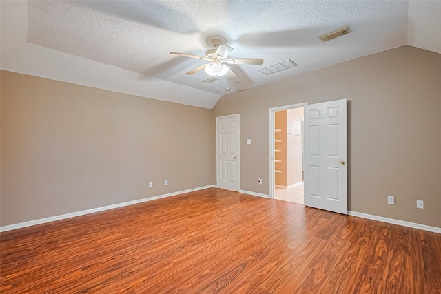 3803 Doveswood Cir, Needville, TX 77461 - empty room with lofted ceiling, a ceiling fan, light wood-type flooring, and a textured ceiling