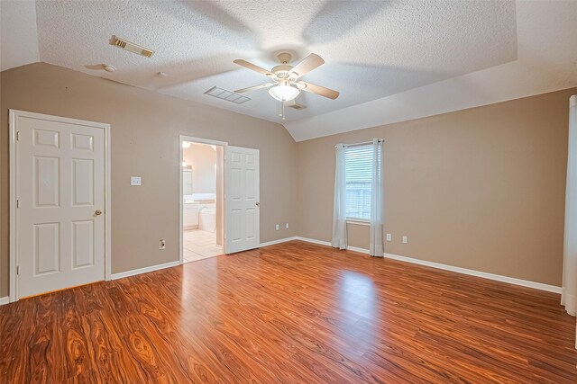 3803 Doveswood Cir, Needville, TX 77461 - empty room featuring vaulted ceiling, a ceiling fan, wood finished floors, and a textured ceiling