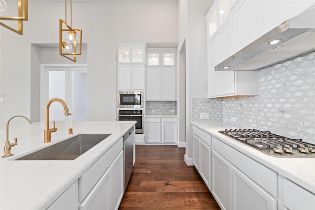 12722 Noble Fields Way, Cypress, TX 77433 - kitchen with wall chimney exhaust hood, stainless steel appliances, dark wood finished floors, white cabinets, and a towering ceiling