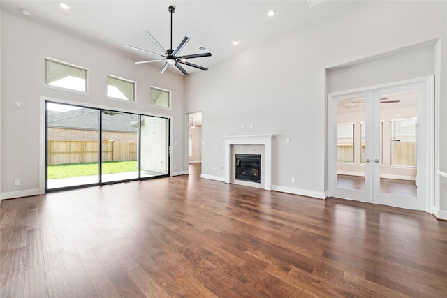 12722 Noble Fields Way, Cypress, TX 77433 - unfurnished living room with ceiling fan, plenty of natural light, wood finished floors, recessed lighting, and a high ceiling
