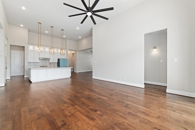 12722 Noble Fields Way, Cypress, TX 77433 - unfurnished living room with ceiling fan, dark wood-style floors, recessed lighting, and a high ceiling