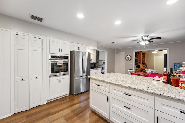 3101 Yost Blvd, Pearland, TX 77581 - kitchen with stainless steel appliances, a ceiling fan, light wood-type flooring, white cabinetry, and recessed lighting