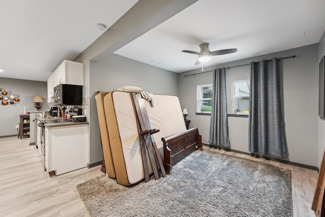 3101 Yost Blvd, Pearland, TX 77581 - interior space with stainless steel microwave, white cabinets, a ceiling fan, and light wood finished floors
