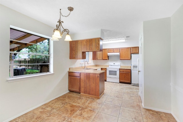 10314 Paintbrush Ln, Sugar Land, TX 77498 - kitchen featuring white appliances, under cabinet range hood, brown cabinetry, a peninsula, and light countertops