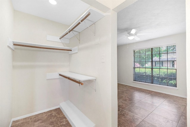 10314 Paintbrush Ln, Sugar Land, TX 77498 - spacious closet with ceiling fan and tile patterned flooring
