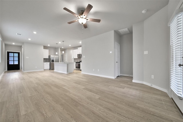 6609 Lahna Oak Dr, Conroe, TX 77304 - unfurnished living room featuring ceiling fan, light wood-style flooring, and recessed lighting