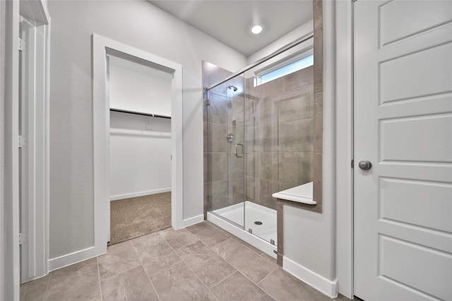 6609 Lahna Oak Dr, Conroe, TX 77304 - bathroom featuring a stall shower and a walk in closet