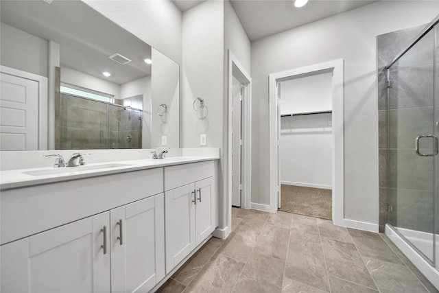 6609 Lahna Oak Dr, Conroe, TX 77304 - full bathroom featuring a walk in closet, a stall shower, double vanity, and recessed lighting