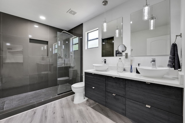 118 Hickory Pnes, Livingston, TX 77351 - full bath featuring a stall shower, double vanity, and wood finished floors