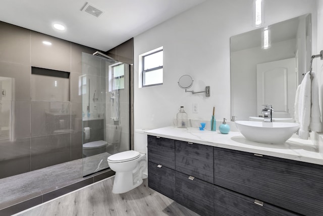 118 Hickory Pnes, Livingston, TX 77351 - full bathroom featuring a shower stall, double vanity, and wood finished floors