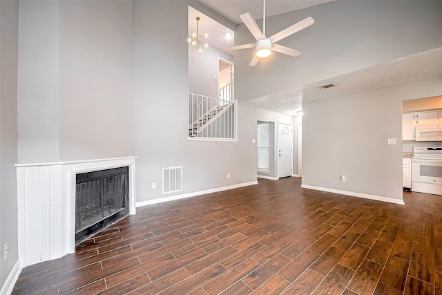 10318 Rockcrest Dr, Houston, TX 77041 - unfurnished living room featuring high vaulted ceiling, ceiling fan, a fireplace, dark wood finished floors, and stairway