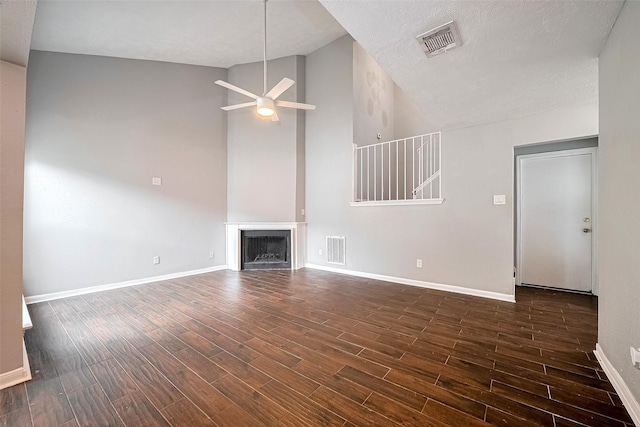 10318 Rockcrest Dr, Houston, TX 77041 - unfurnished living room with a ceiling fan, dark wood-style flooring, a fireplace, and high vaulted ceiling