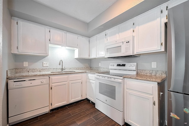 10318 Rockcrest Dr, Houston, TX 77041 - kitchen featuring white appliances, dark wood-style flooring, white cabinets, and light stone counters