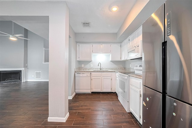 10318 Rockcrest Dr, Houston, TX 77041 - kitchen with white appliances, a ceiling fan, white cabinets, dark wood finished floors, and light stone countertops