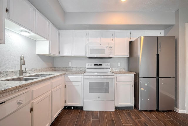 10318 Rockcrest Dr, Houston, TX 77041 - kitchen featuring white appliances, wood finish floors, white cabinetry, and light stone counters