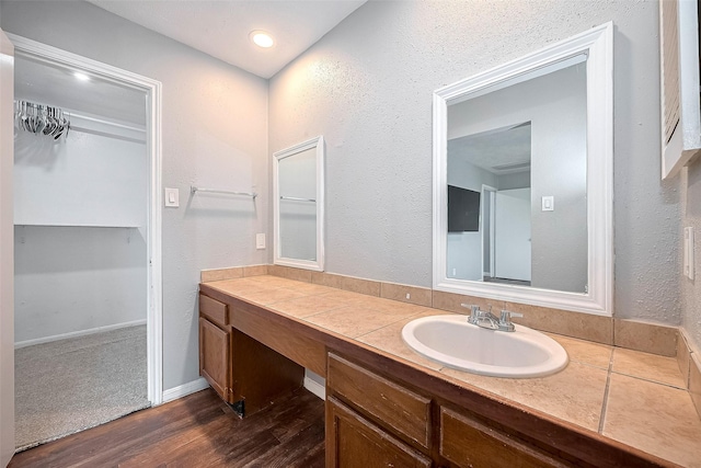 10318 Rockcrest Dr, Houston, TX 77041 - bathroom with vanity, wood finished floors, and a spacious closet