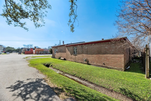 4110 N Main St, Houston, TX 77009 - view of side of home featuring brick siding and a lawn