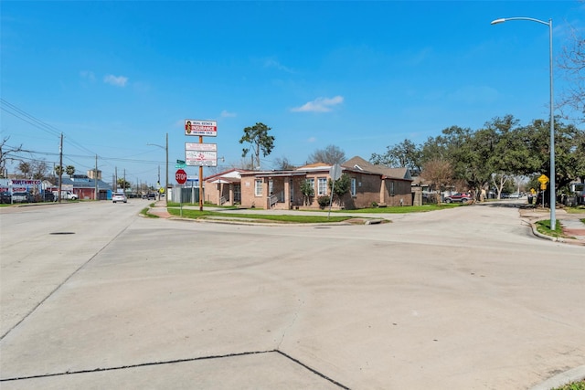 4110 N Main St, Houston, TX 77009 - view of concrete street featuring traffic signs, street lighting, sidewalks, and curbs