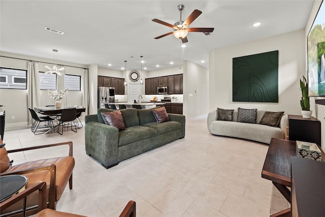 15247 Parkland Canyon Dr, Cypress, TX 77433 - living room featuring a chandelier, recessed lighting, ceiling fan, and light tile patterned floors