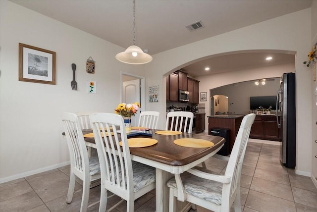 30119 Saw Oaks Dr, Magnolia, TX 77355 - dining area with arched walkways, light tile patterned flooring, a ceiling fan, and recessed lighting