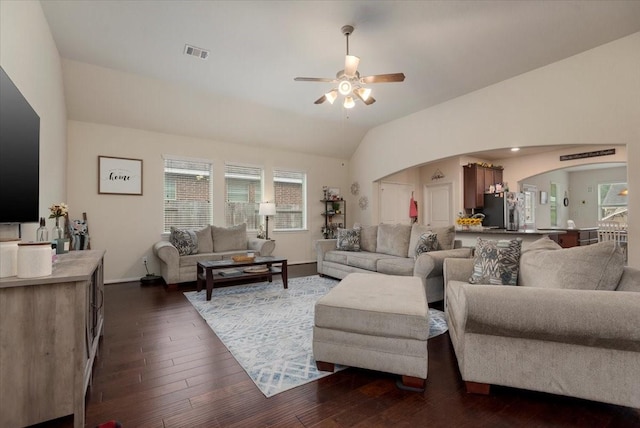 30119 Saw Oaks Dr, Magnolia, TX 77355 - living area featuring a ceiling fan, arched walkways, vaulted ceiling, plenty of natural light, and dark wood-style flooring