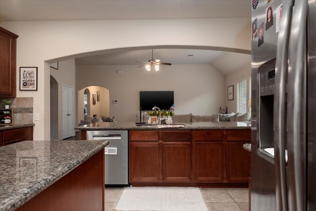 30119 Saw Oaks Dr, Magnolia, TX 77355 - kitchen featuring stainless steel appliances, ceiling fan, open floor plan, dark stone countertops, and vaulted ceiling
