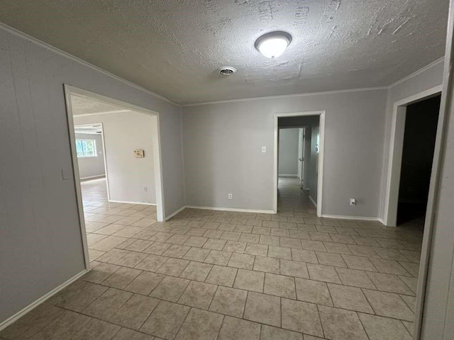 7717 Bigwood St, Houston, TX 77016 - spare room with ornamental molding, a textured ceiling, and tile patterned floors