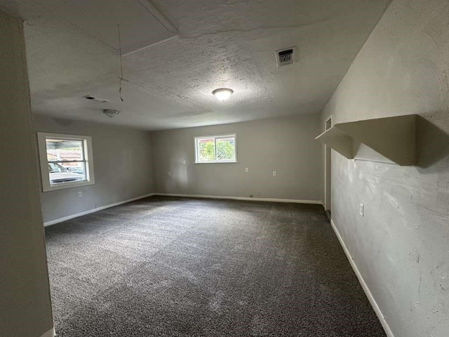 7717 Bigwood St, Houston, TX 77016 - spare room with attic access, carpet flooring, and a textured ceiling