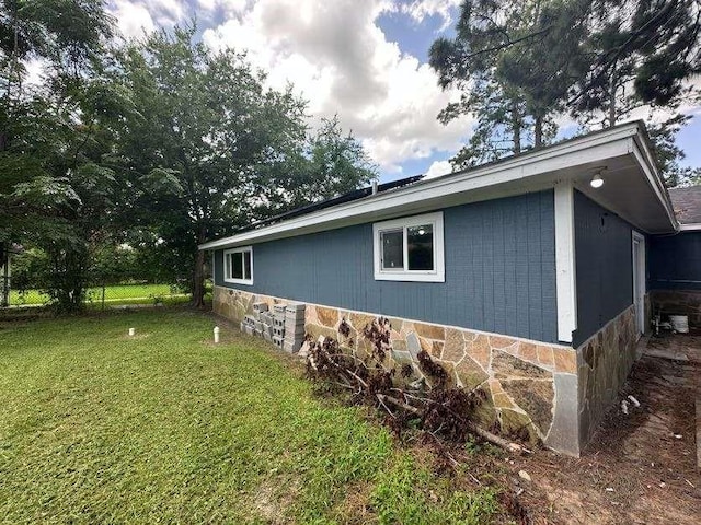 7717 Bigwood St, Houston, TX 77016 - view of property exterior with a lawn and stone siding