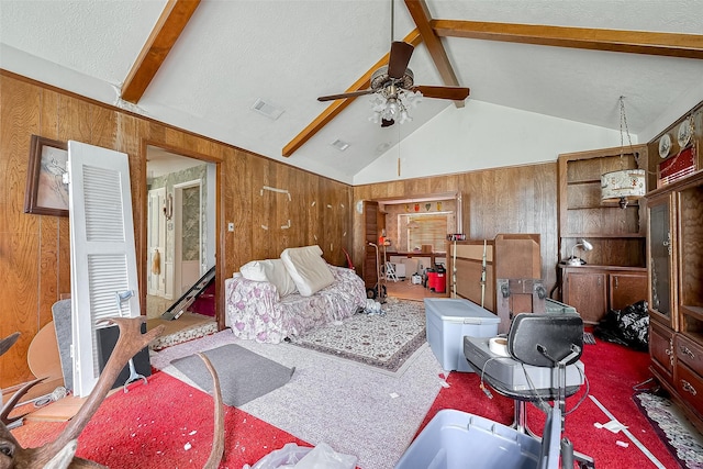 25107 Broughton St, Spring, TX 77373 - carpeted living room with wood walls, a ceiling fan, and a textured ceiling