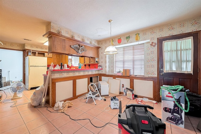 25107 Broughton St, Spring, TX 77373 - dining space featuring wallpapered walls, a textured ceiling, and light tile patterned floors