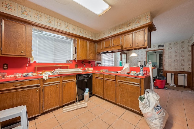 25107 Broughton St, Spring, TX 77373 - kitchen with wallpapered walls, dishwasher, brown cabinetry, light tile patterned floors, and light countertops