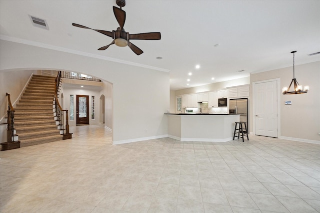 15411 Driftwood Oak Ct, Houston, TX 77059 - unfurnished living room with light tile patterned floors, arched walkways, a ceiling fan, a chandelier, and ornamental molding